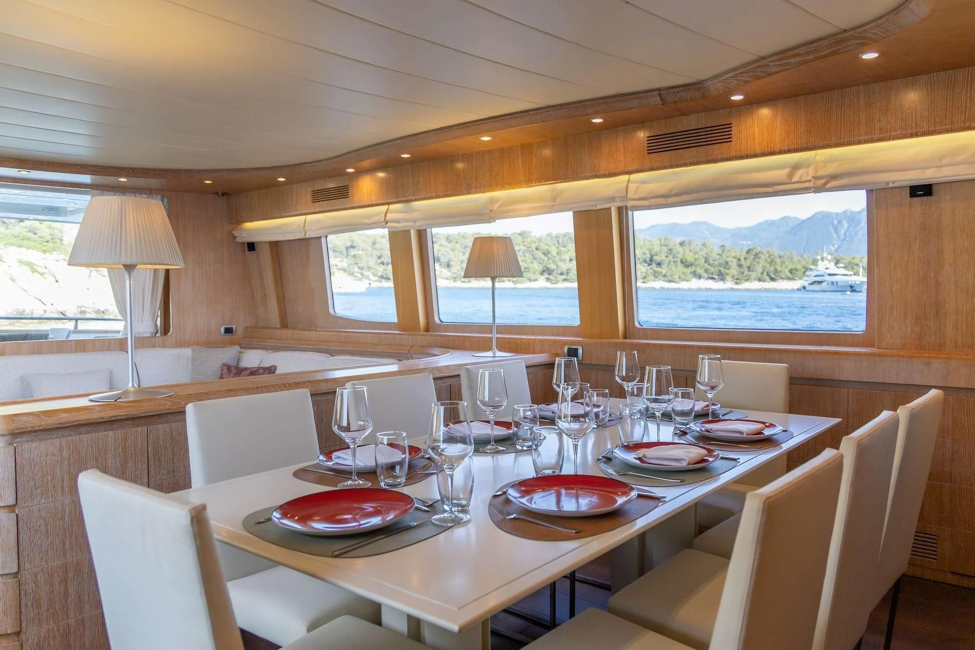 a dining table with plates and glasses aboard COOKIE Yacht for Charter