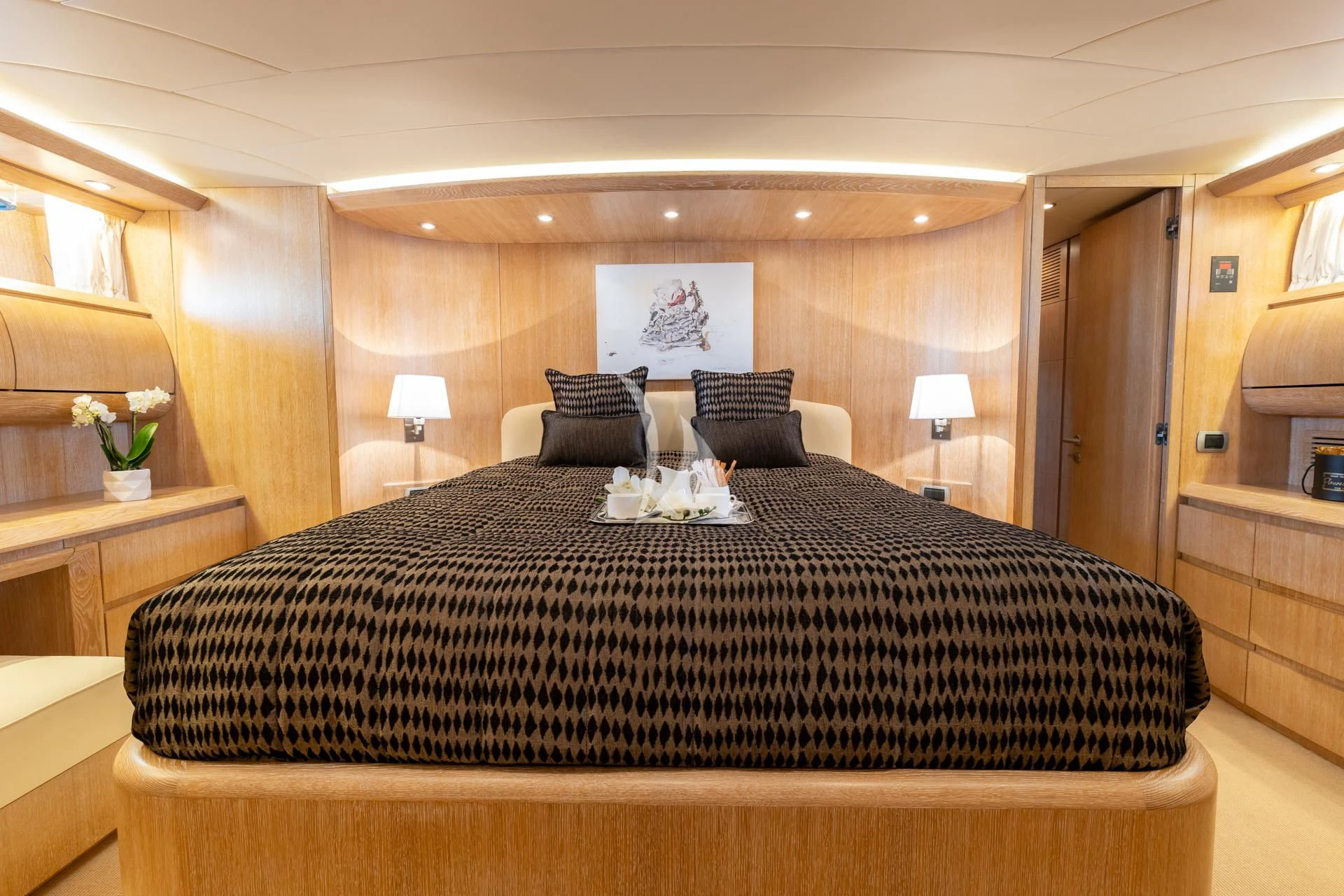 a bed with a black comforter aboard COOKIE Yacht for Charter