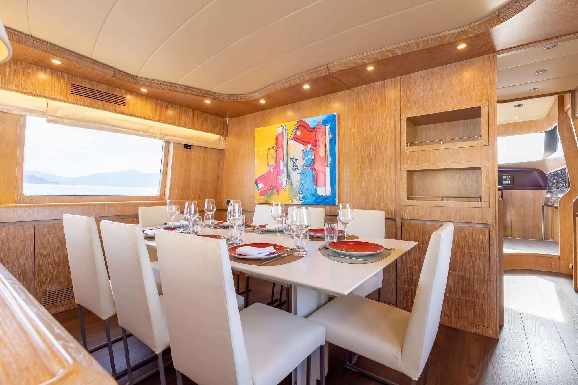 a dining table with chairs and a window aboard COOKIE Yacht for Charter