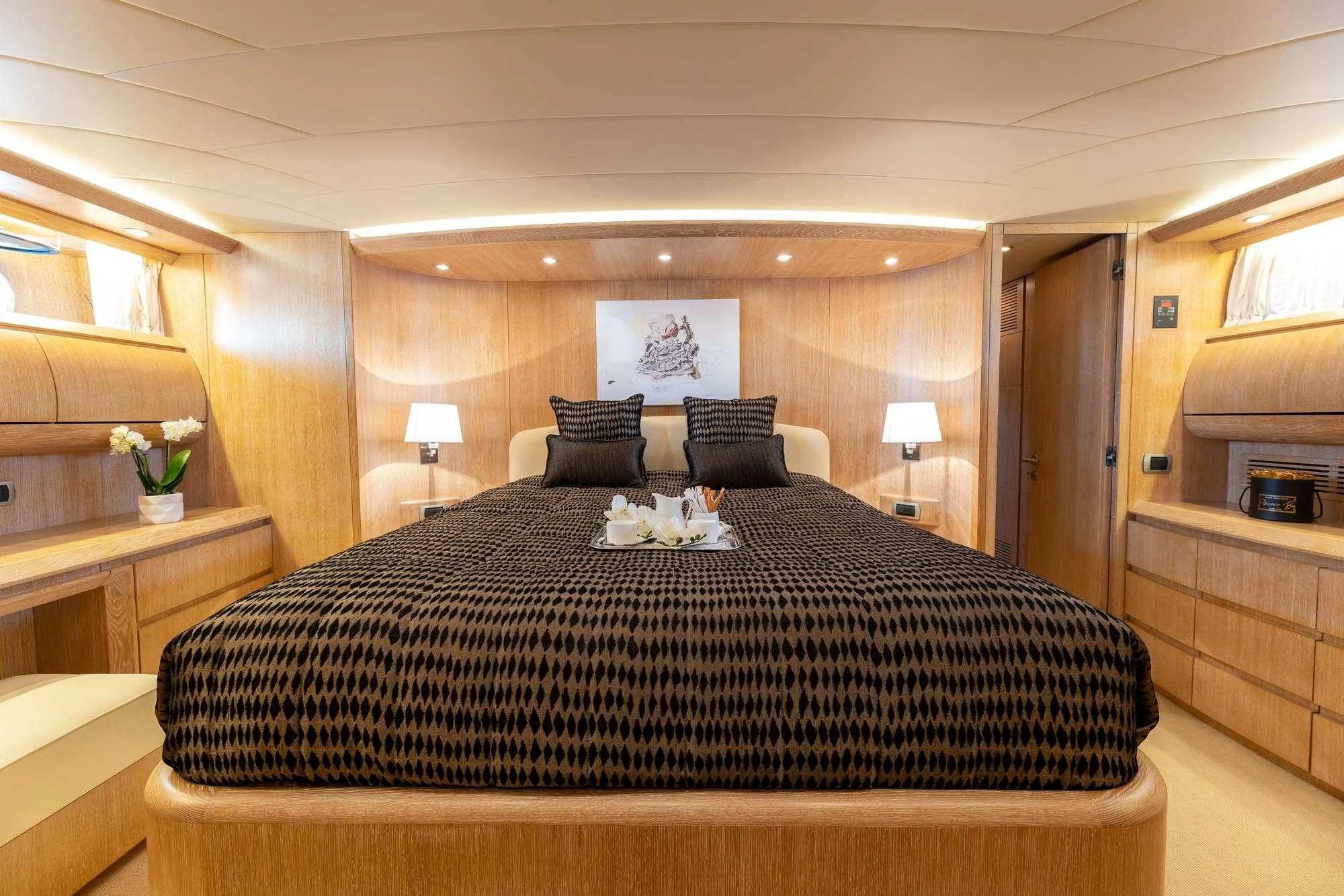 a bed with a black comforter aboard COOKIE Yacht for Charter