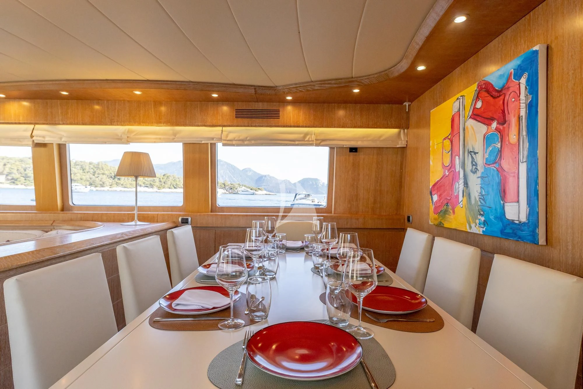 a dining table with plates and glasses aboard COOKIE Yacht for Charter