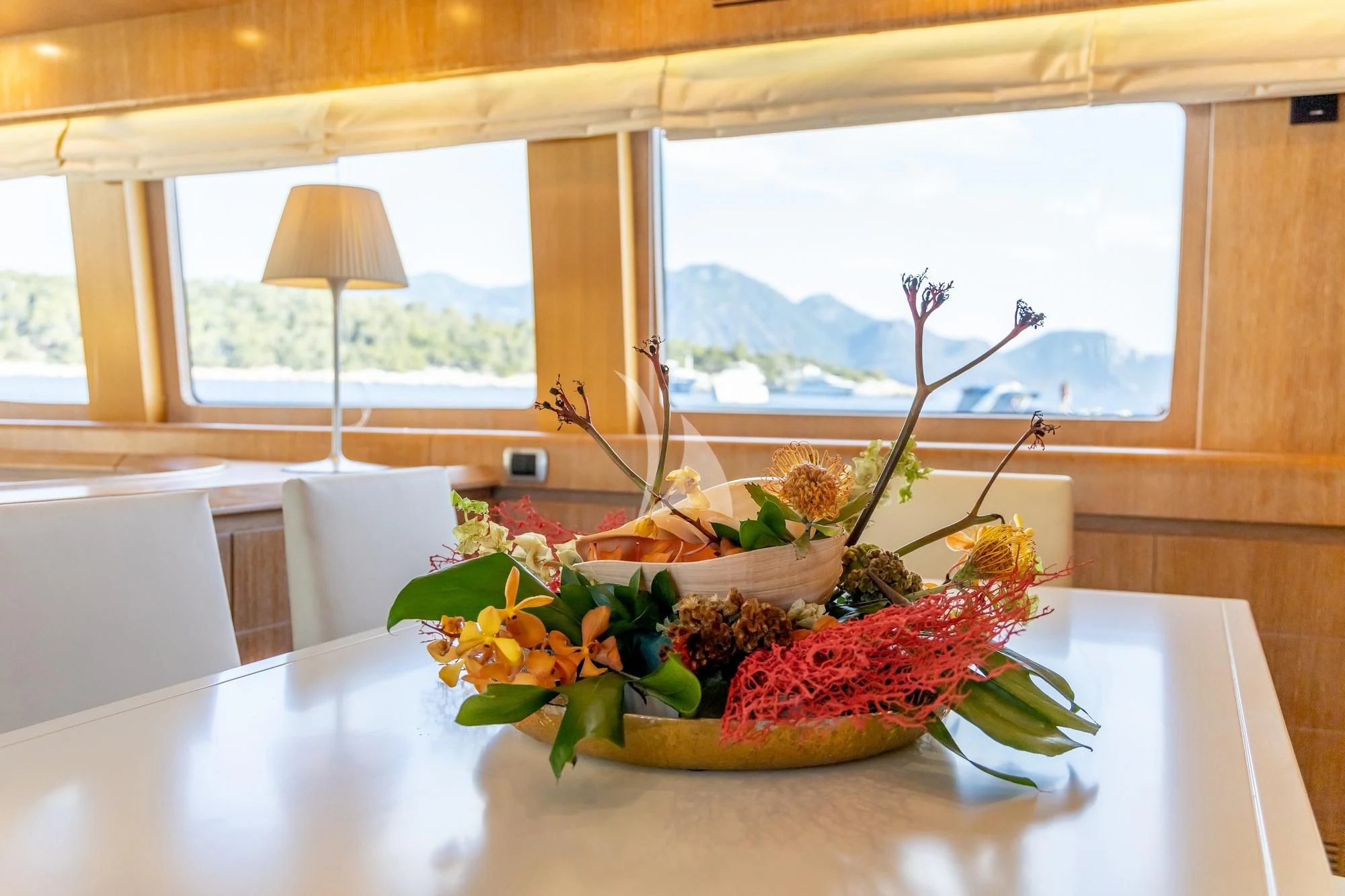 a table with a plant and a lamp on it aboard COOKIE Yacht for Charter