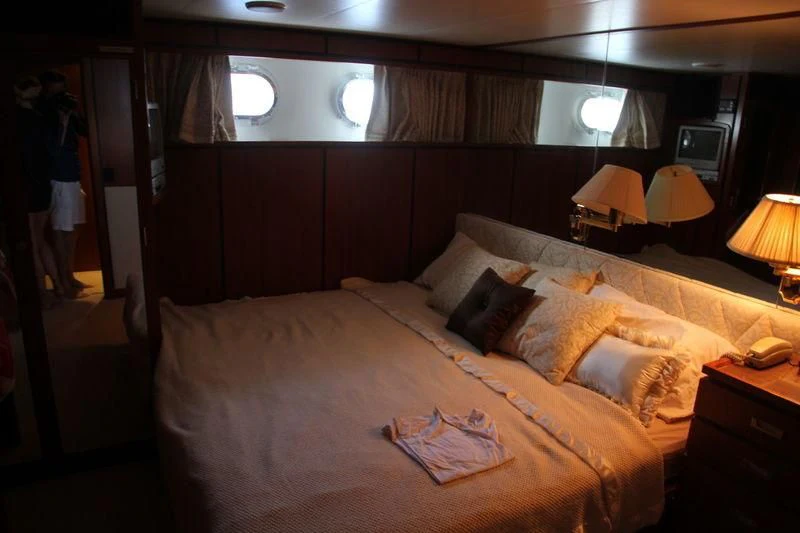 a bed with a white comforter aboard SEAGULL OF CAYMAN Yacht for Sale