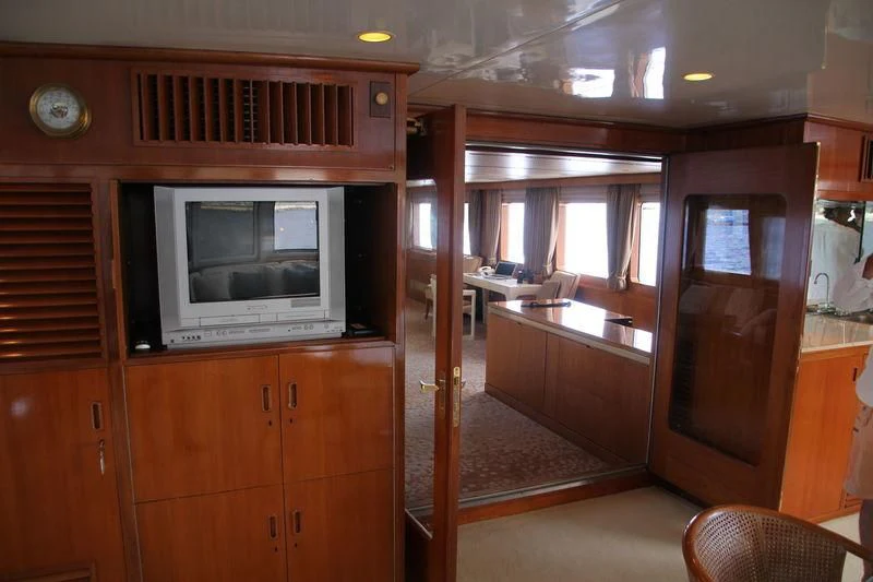 a room with a tv and a cabinet aboard SEAGULL OF CAYMAN Yacht for Sale
