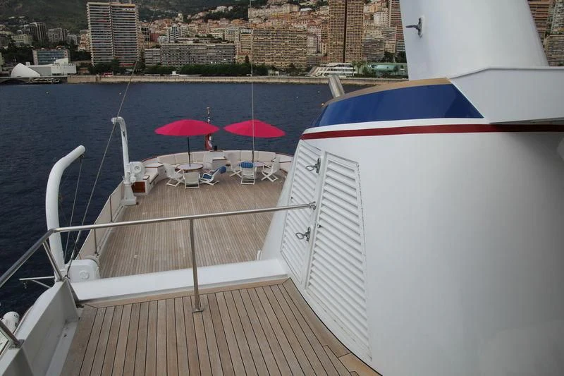 a deck with chairs and umbrellas aboard SEAGULL OF CAYMAN Yacht for Sale