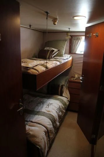 a bedroom with two beds aboard SEAGULL OF CAYMAN Yacht for Sale