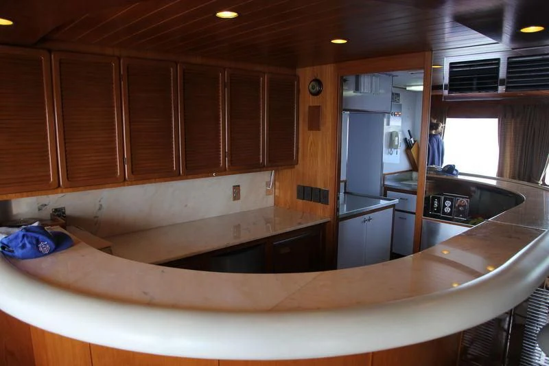 a kitchen with wooden cabinets aboard SEAGULL OF CAYMAN Yacht for Sale