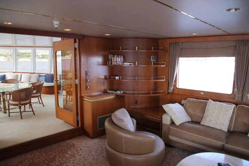 a living room with a bookcase aboard SEAGULL OF CAYMAN Yacht for Sale
