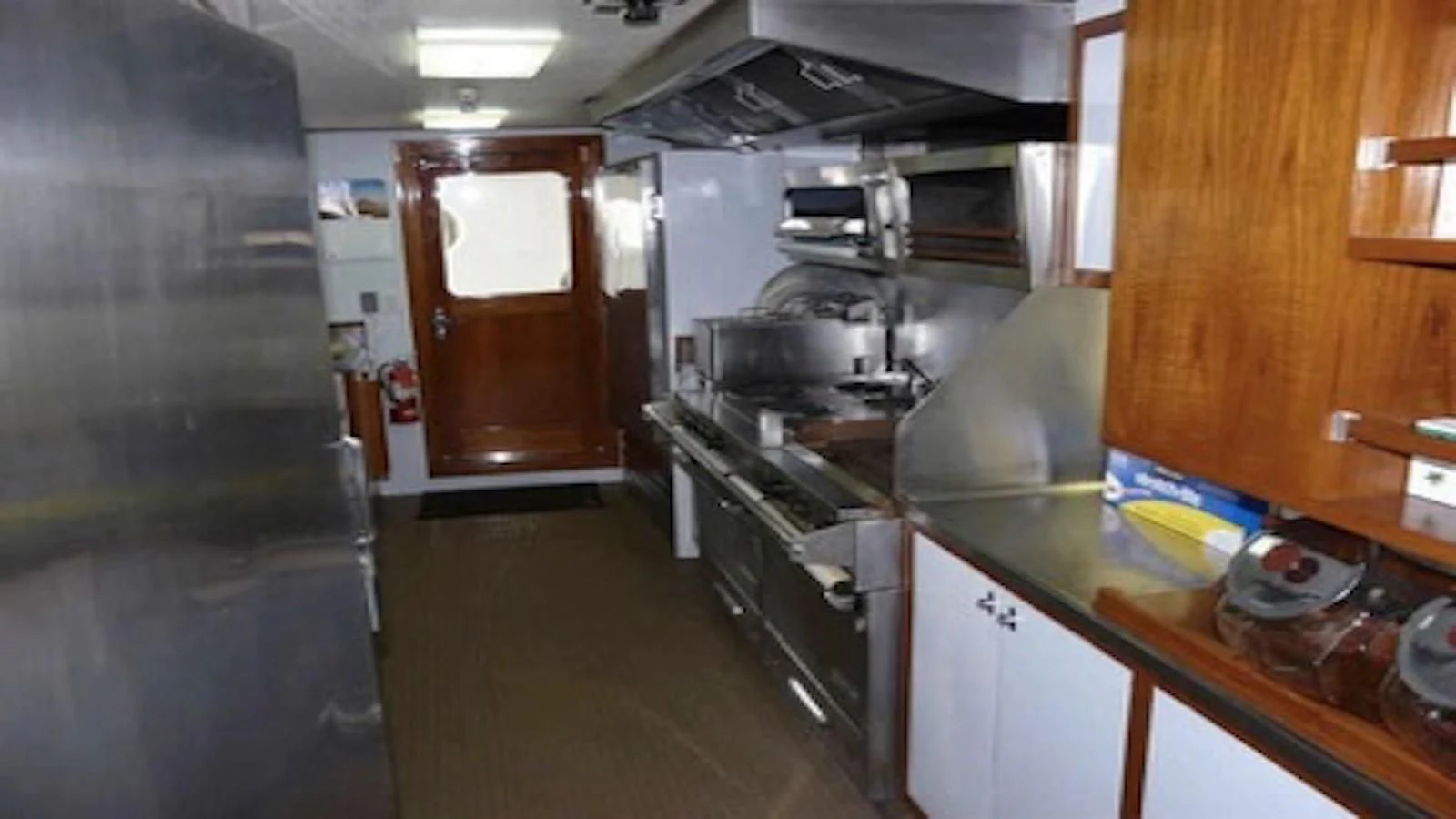 a kitchen with a stove and cabinets aboard SEAGULL OF CAYMAN Yacht for Sale