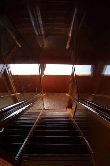 a dark wooden staircase aboard SEAGULL OF CAYMAN Yacht for Sale