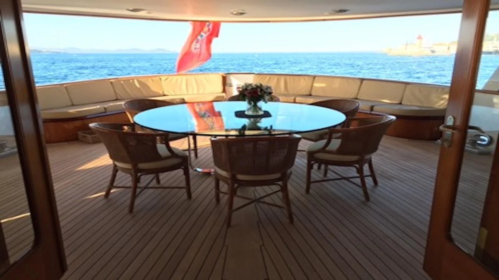a table and chairs on a deck aboard SEAGULL OF CAYMAN Yacht for Sale