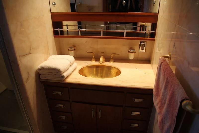a bathroom with a sink and a mirror aboard SEAGULL OF CAYMAN Yacht for Sale