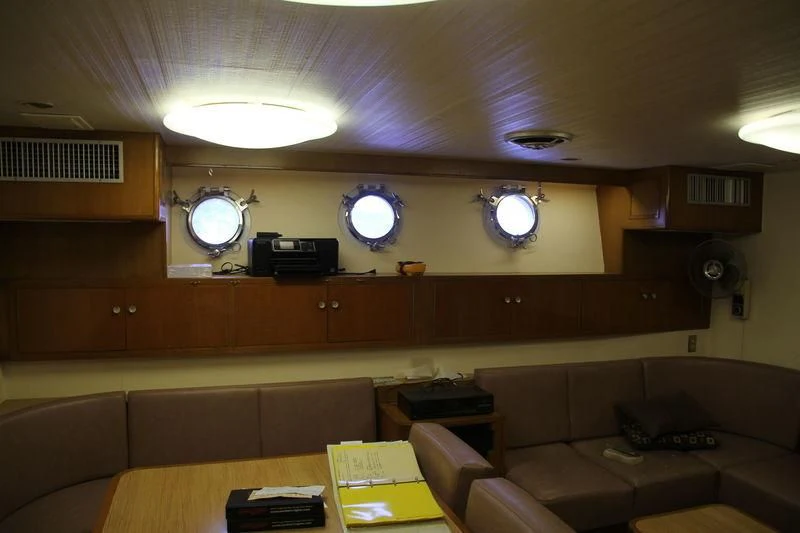 a room with a couch and a mirror aboard SEAGULL OF CAYMAN Yacht for Sale