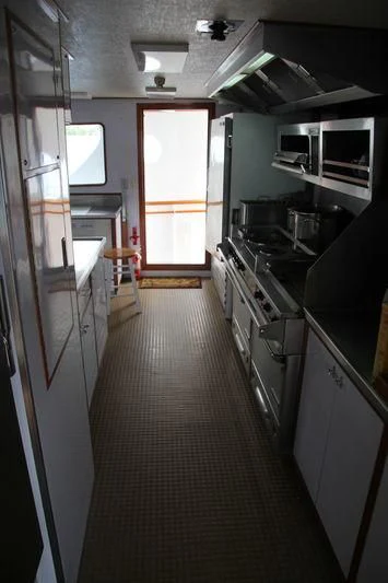 a kitchen with a long hallway aboard SEAGULL OF CAYMAN Yacht for Sale