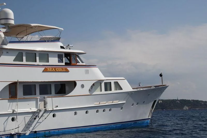 a white yacht on the water aboard SEAGULL OF CAYMAN Yacht for Sale