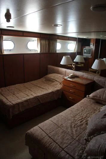 a bedroom with two beds aboard SEAGULL OF CAYMAN Yacht for Sale