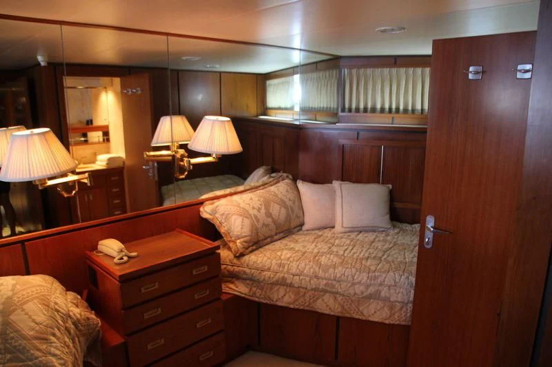 a hotel room with a bed and a desk aboard SEAGULL OF CAYMAN Yacht for Sale