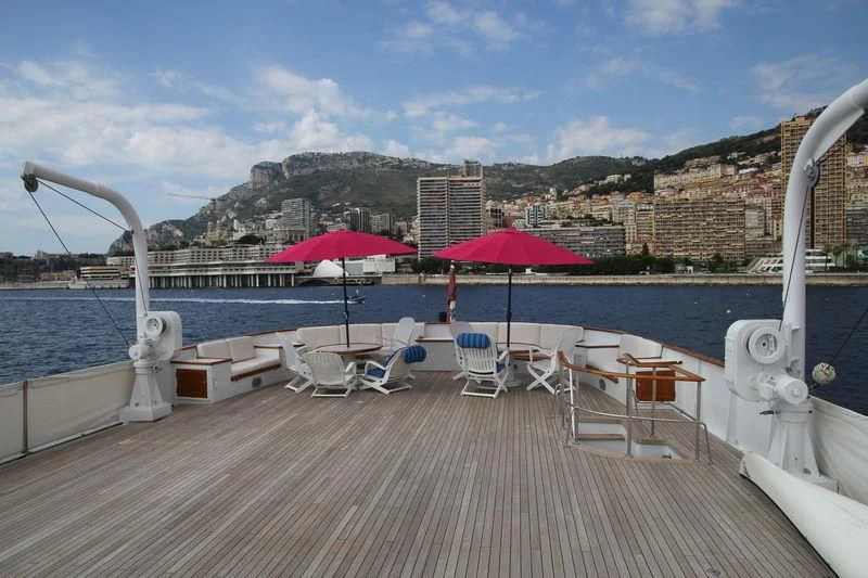 a deck with chairs and umbrellas aboard SEAGULL OF CAYMAN Yacht for Sale