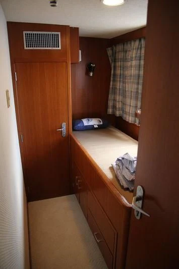 a room with a bed and a closet aboard SEAGULL OF CAYMAN Yacht for Sale