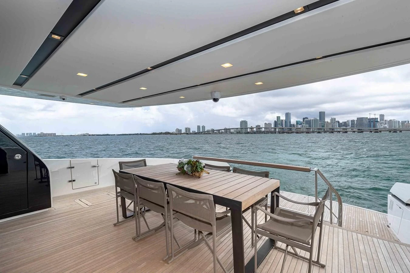 a table and chairs on a deck overlooking a city aboard MAVE Yacht for Sale
