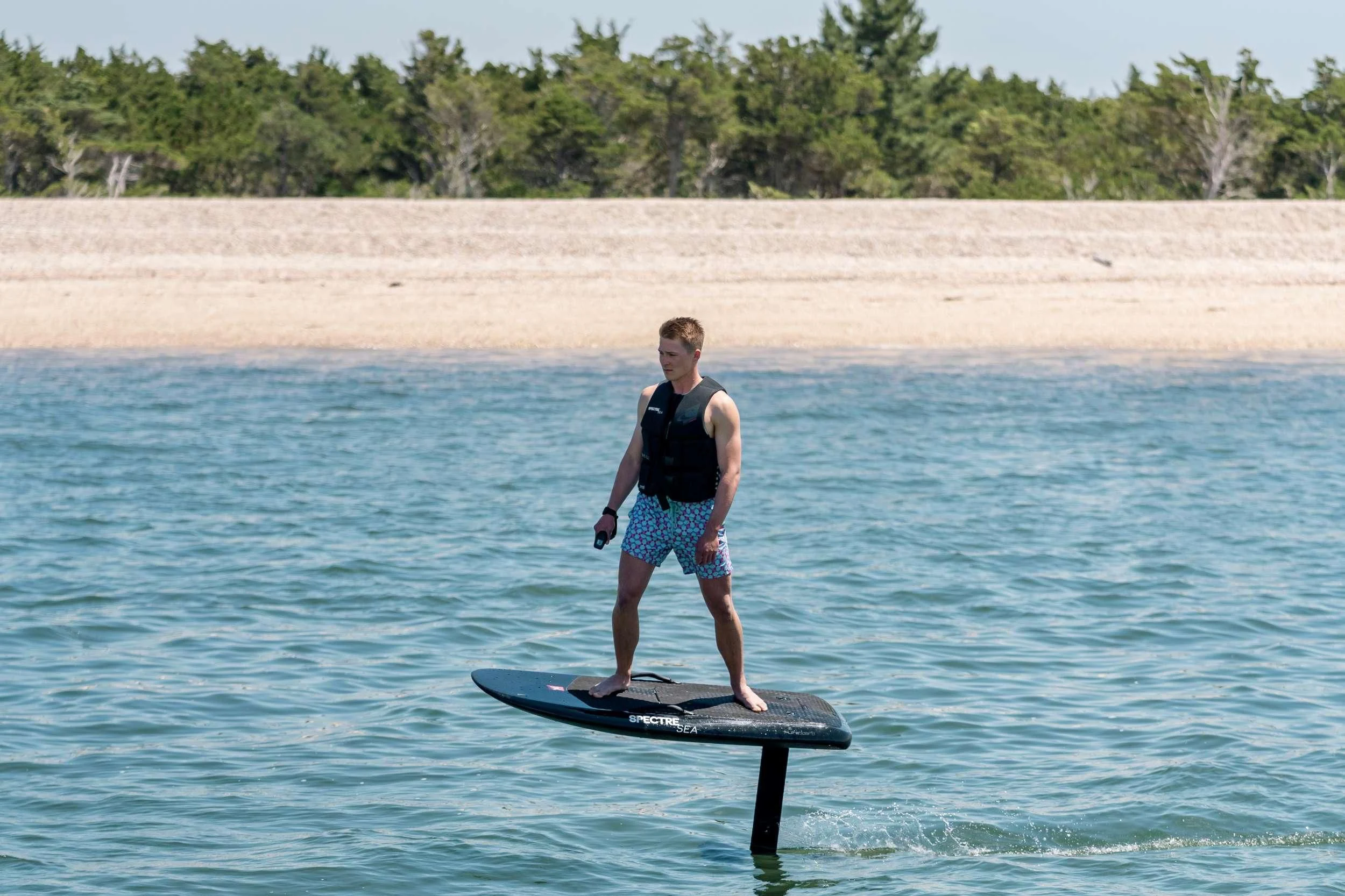 a man standing on a surfboard in the water aboard MAVE Yacht for Sale