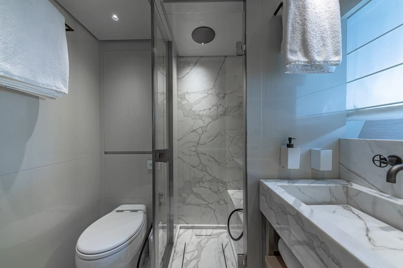 a bathroom with a tub toilet and sink aboard MAVE Yacht for Sale
