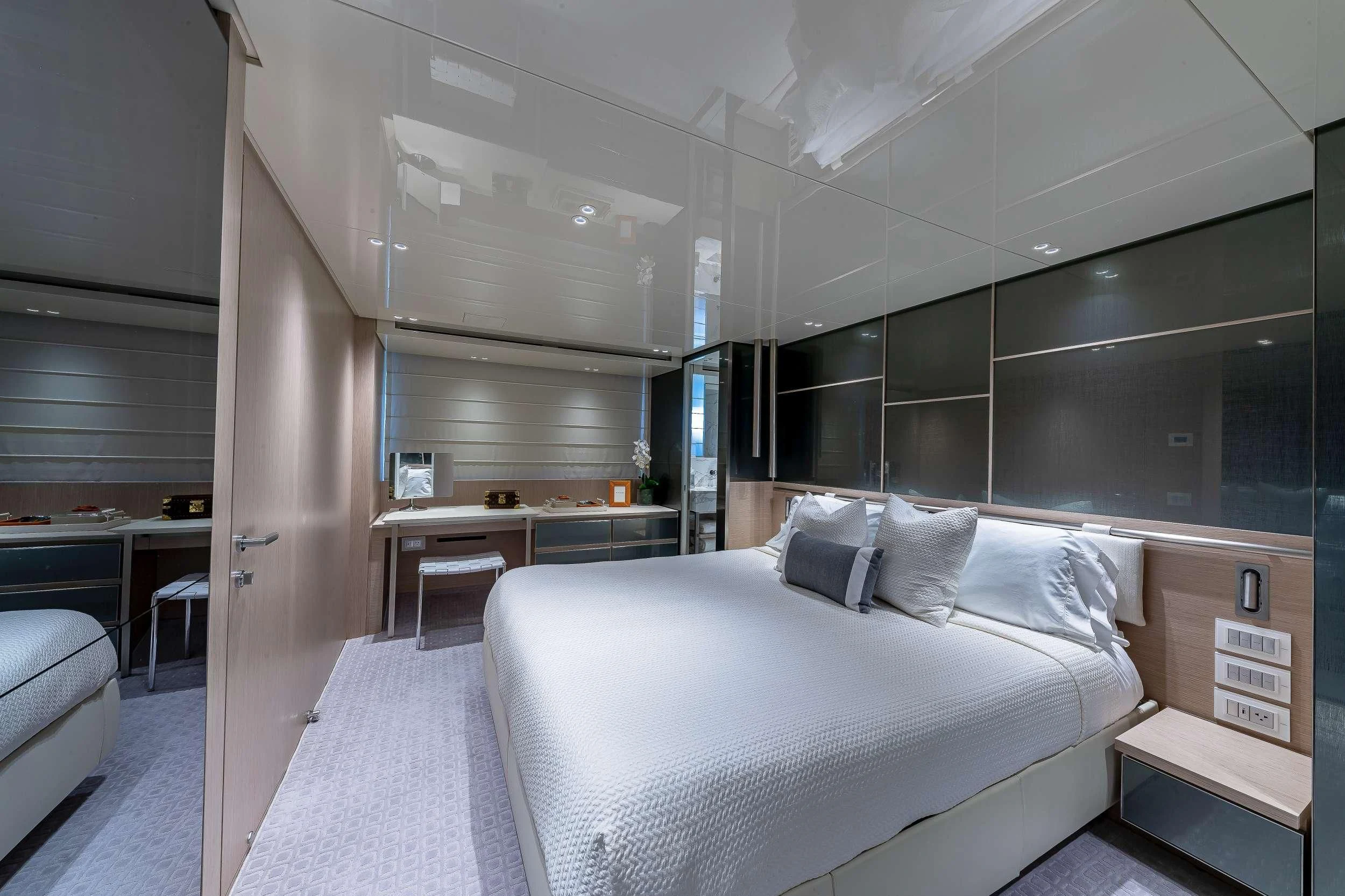 a room with a bed and desk aboard MAVE Yacht for Sale