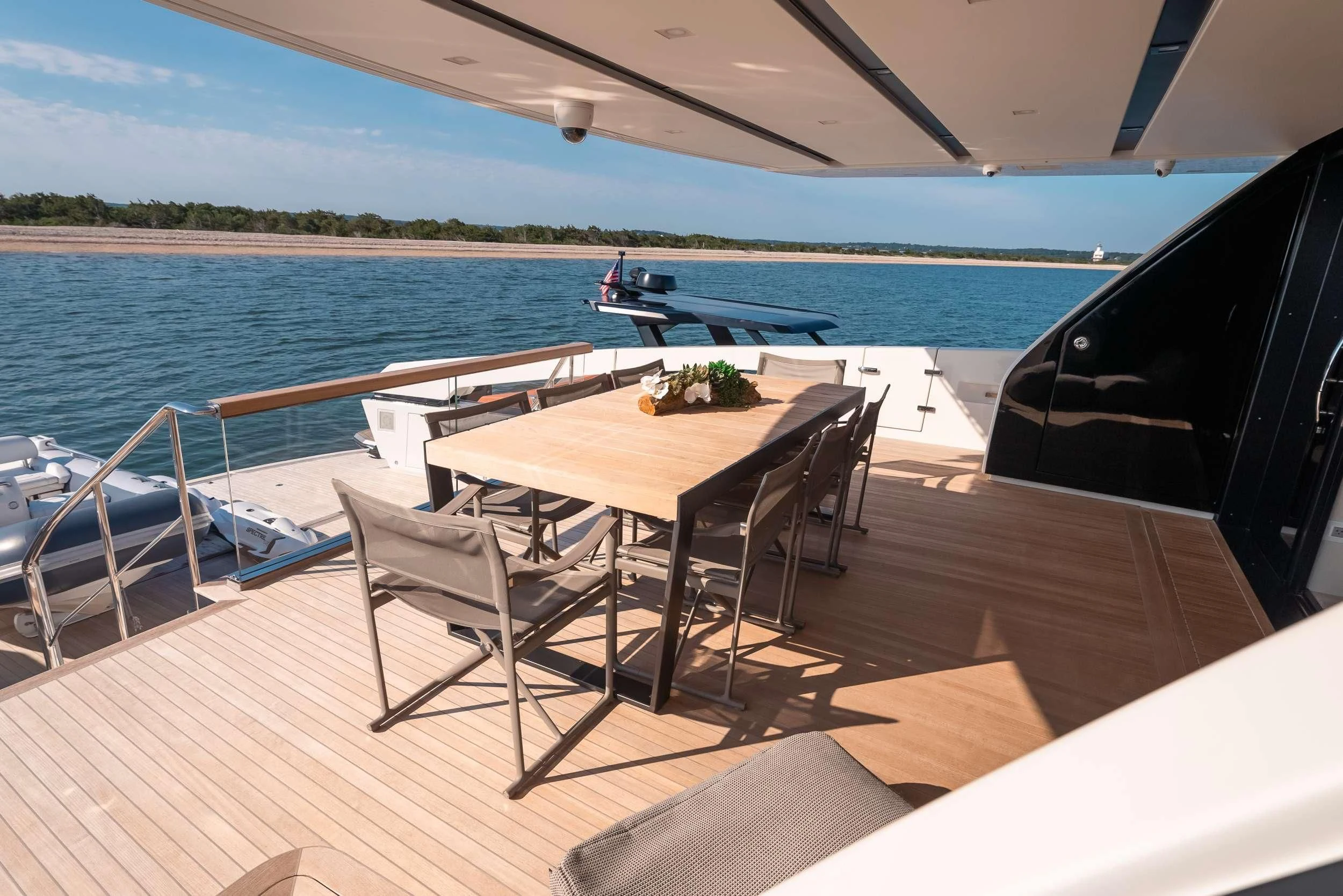 a deck with chairs and tables on it by the water aboard MAVE Yacht for Sale
