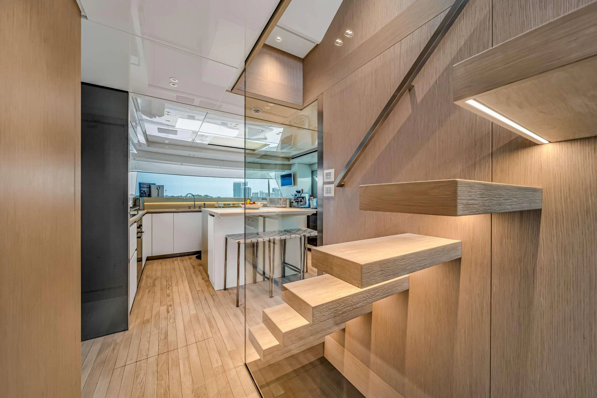 a room with wooden floors and a wood staircase aboard MAVE Yacht for Sale