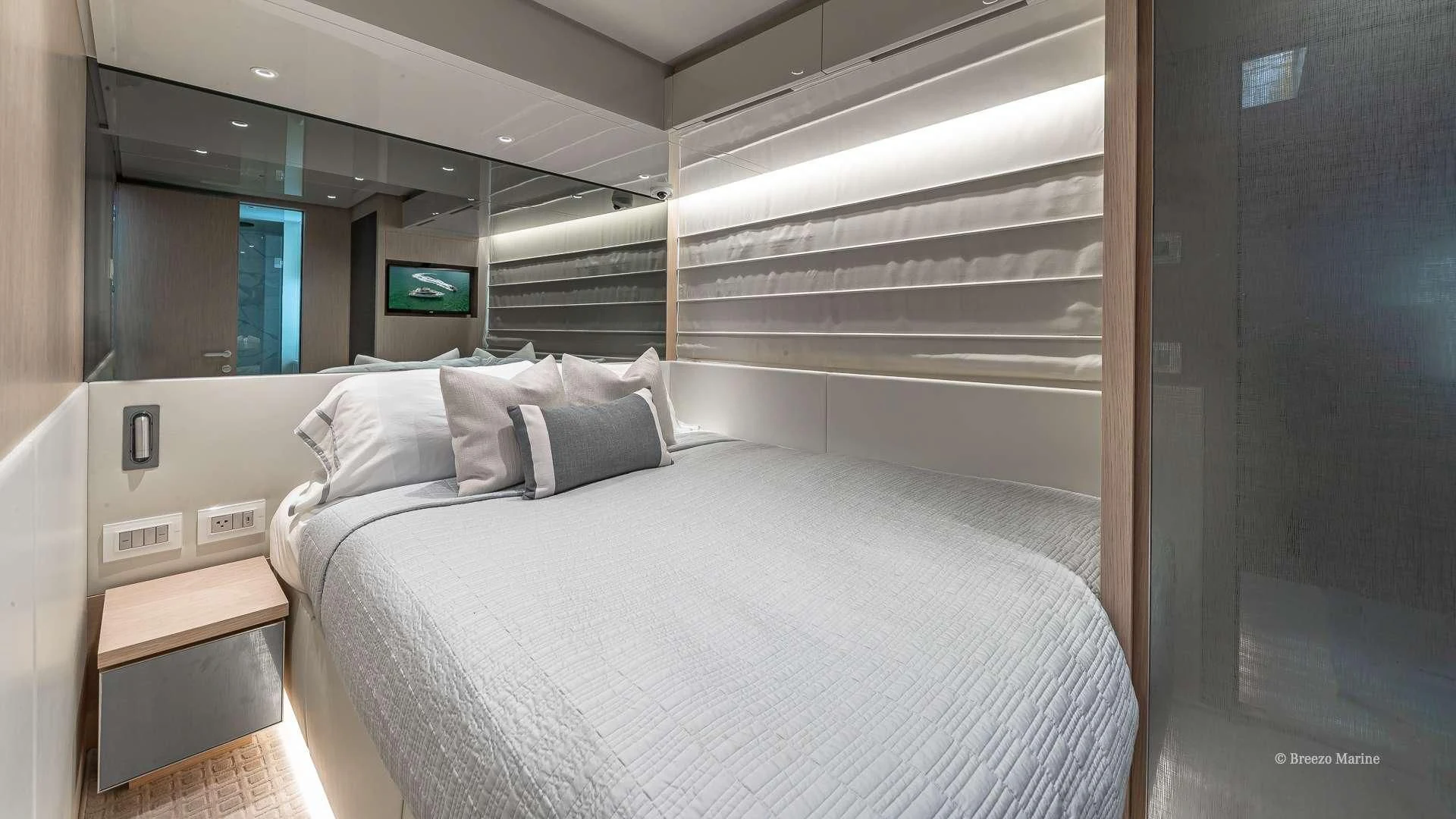 a room with a bed and a television aboard MAVE Yacht for Sale