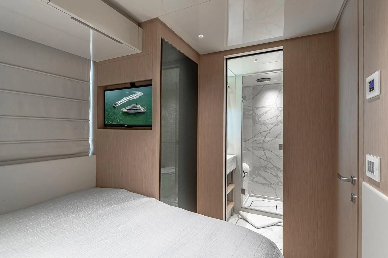 a hotel room with a television on the wall aboard MAVE Yacht for Sale