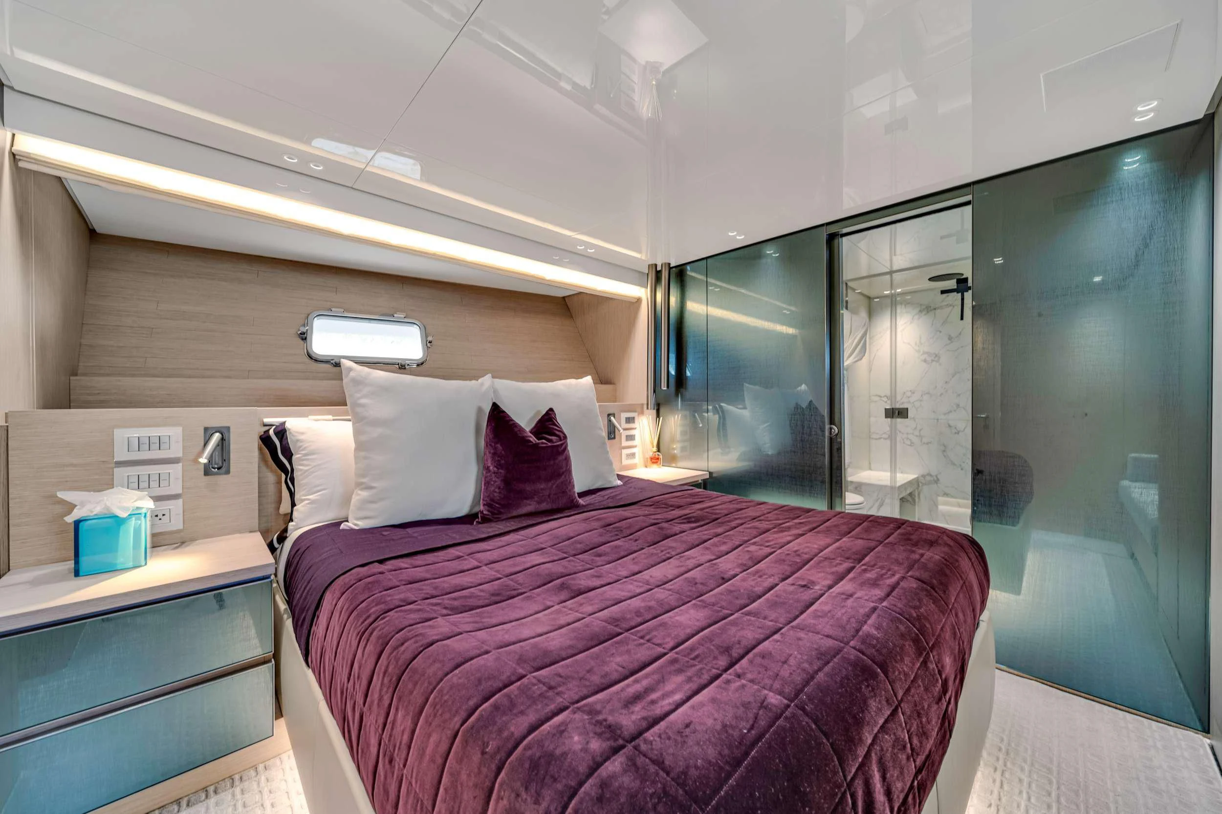 a bed with a purple comforter aboard MAVE Yacht for Sale