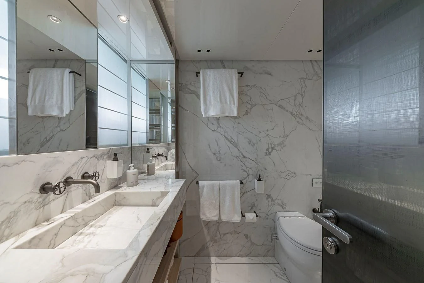 a bathroom with a tub sink and toilet aboard MAVE Yacht for Sale