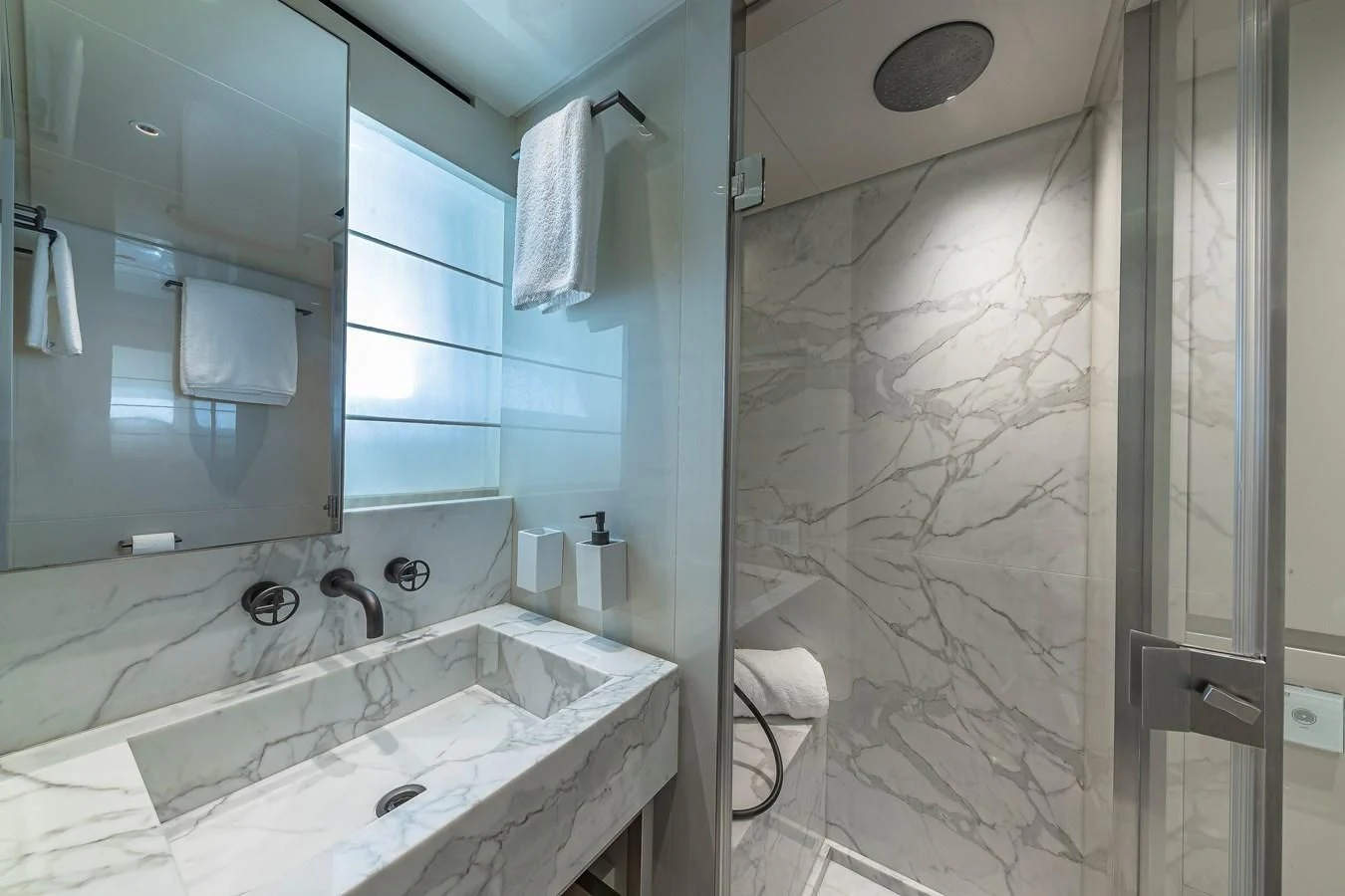 a bathroom with a sink and a mirror aboard MAVE Yacht for Sale