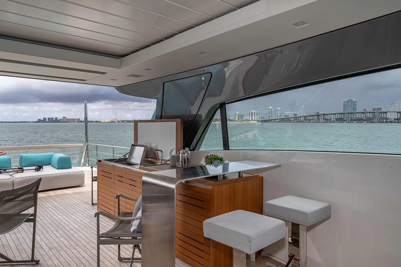 a room with a table and chairs and a view of the water aboard MAVE Yacht for Sale