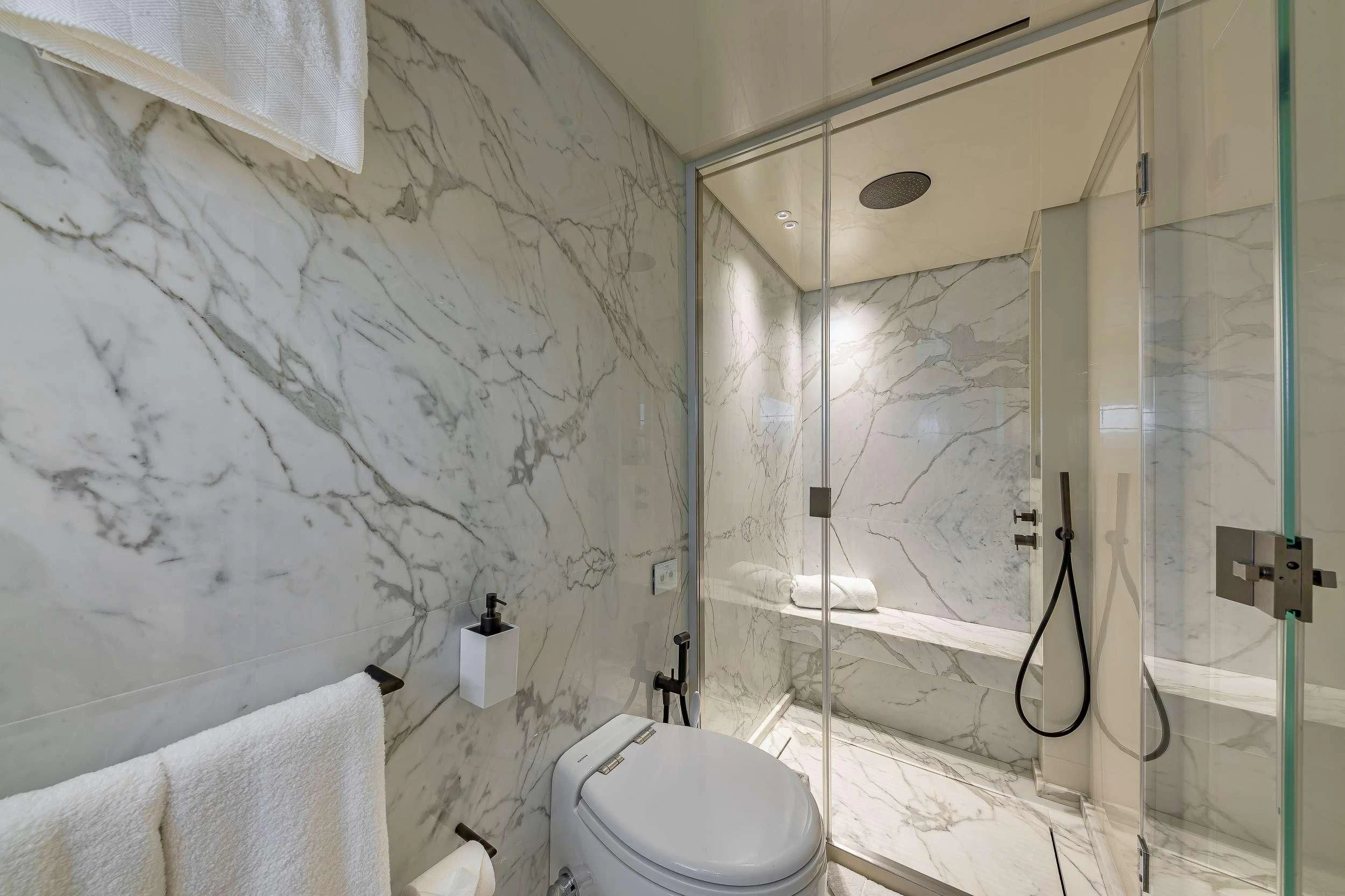 a bathroom with a glass shower aboard MAVE Yacht for Sale