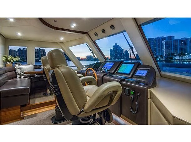 inside of a car with a desk and chairs and a laptop on the table aboard PRIMA MEA Yacht for Sale