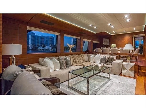 a living room with a large screen aboard PRIMA MEA Yacht for Sale