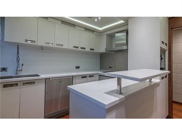 a kitchen with white cabinets aboard PRIMA MEA Yacht for Sale
