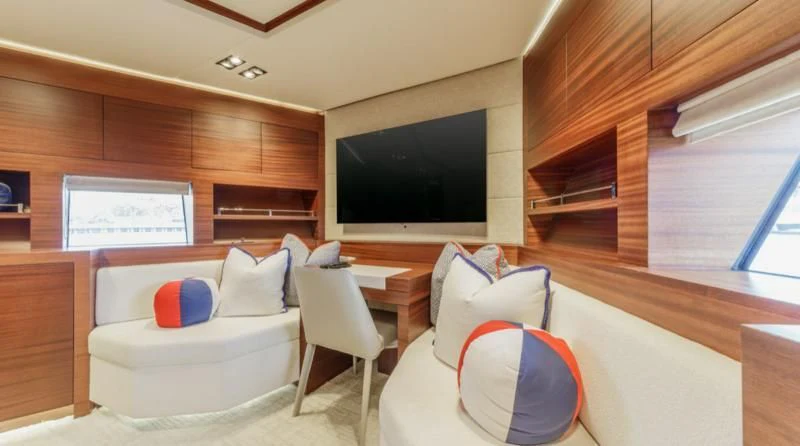 a room with a couch and a tv aboard PRIMA MEA Yacht for Sale