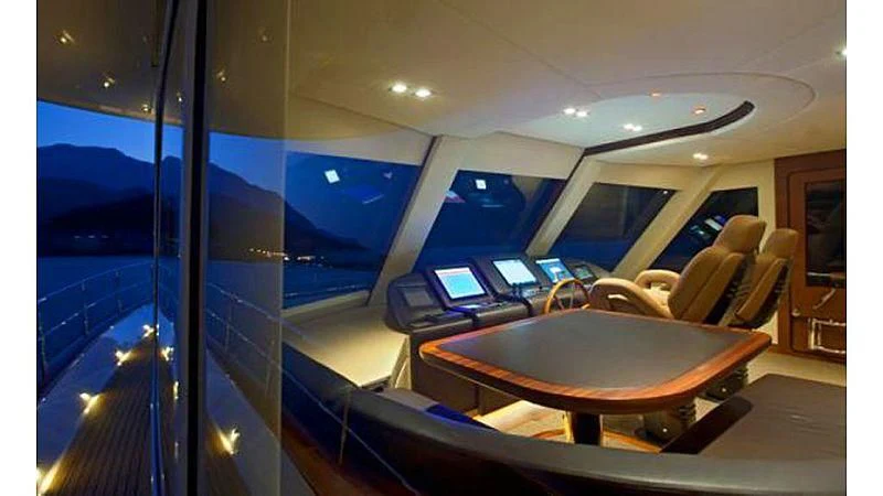 a room with a table and laptops aboard PRIMA MEA Yacht for Sale