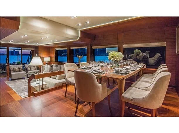 a dining room with a table and chairs aboard PRIMA MEA Yacht for Sale
