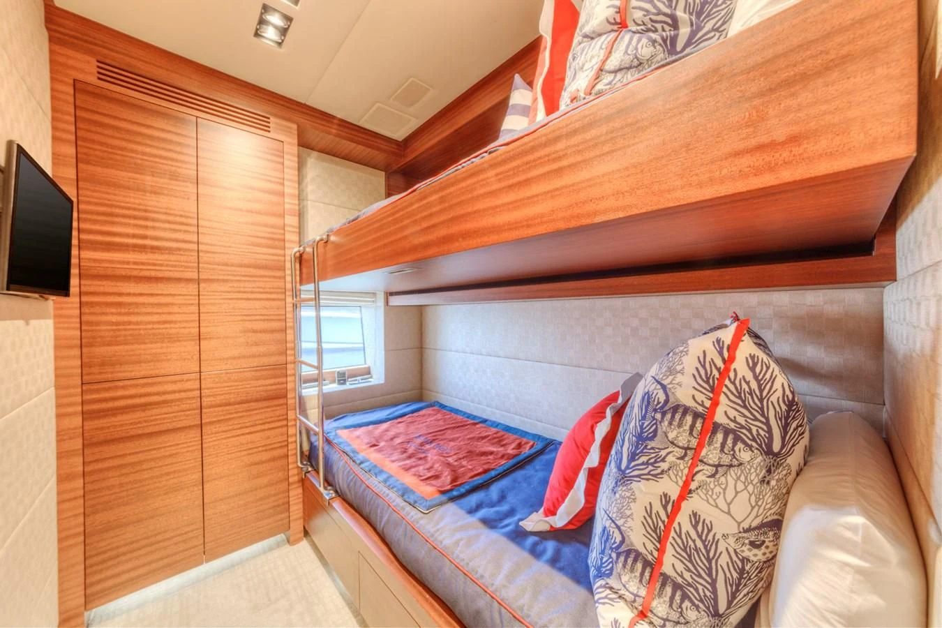 a bed with a blue sheet aboard PRIMA MEA Yacht for Sale