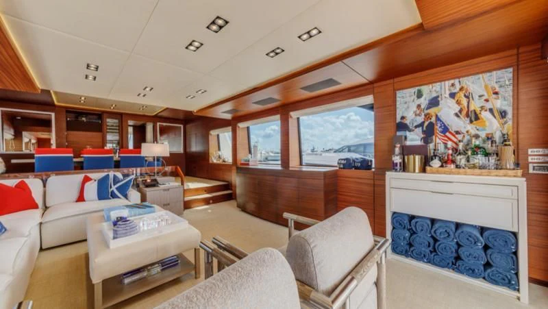 a room with a couch and a table and a window aboard PRIMA MEA Yacht for Sale