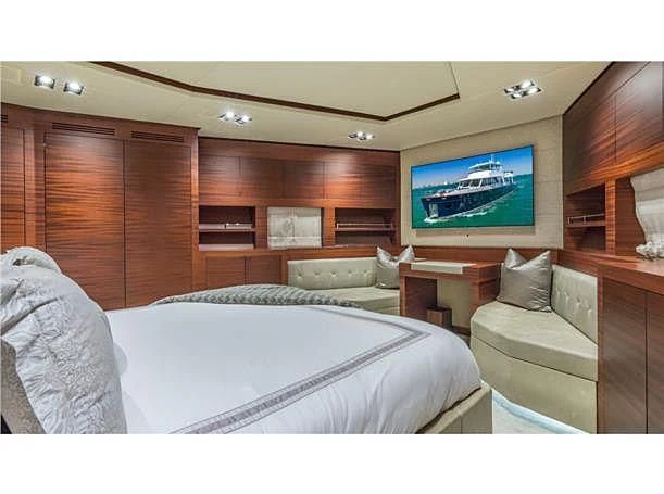 a room with a bed and a television aboard PRIMA MEA Yacht for Sale