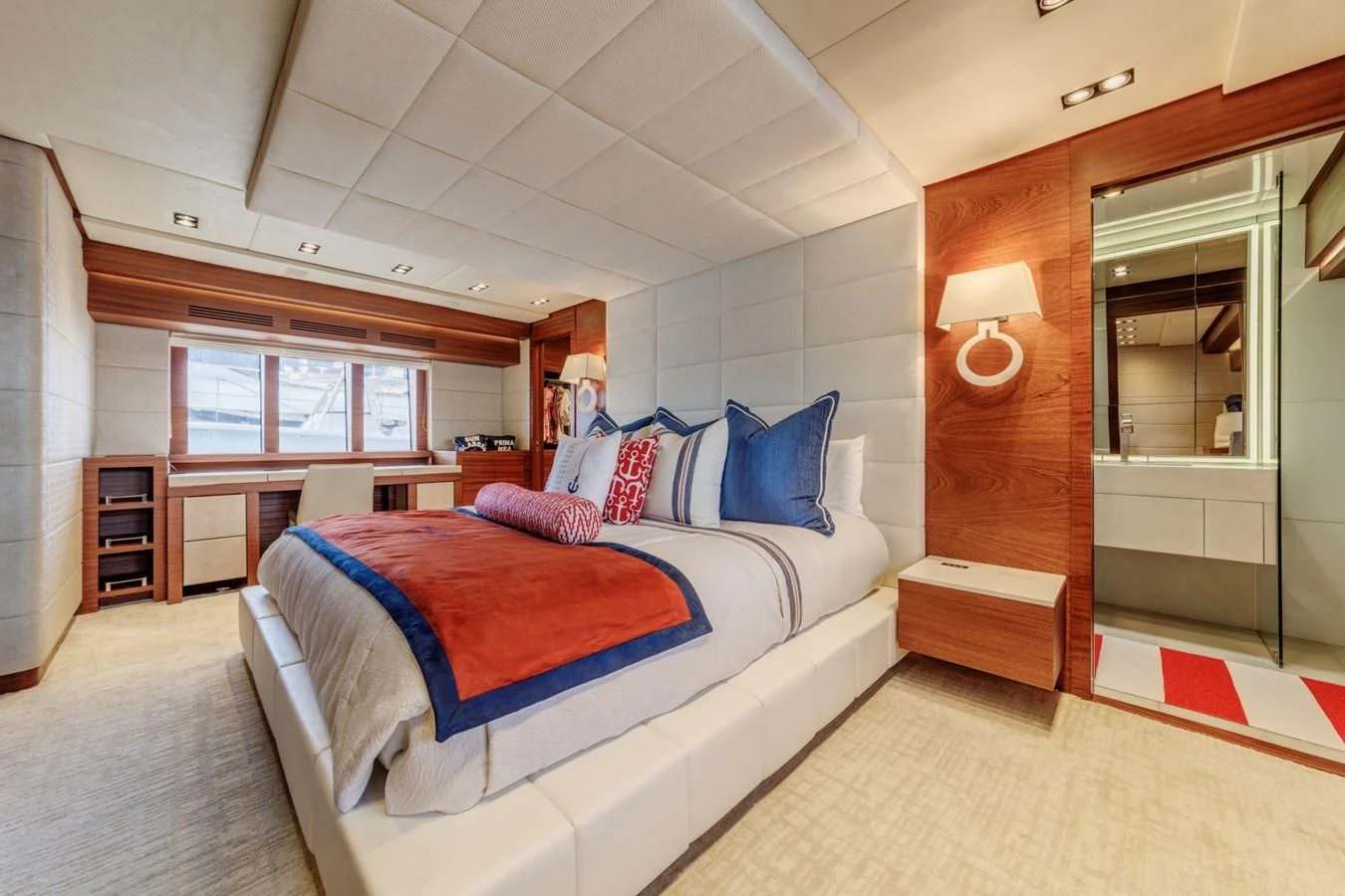a bedroom with a bed and a mirror aboard PRIMA MEA Yacht for Sale