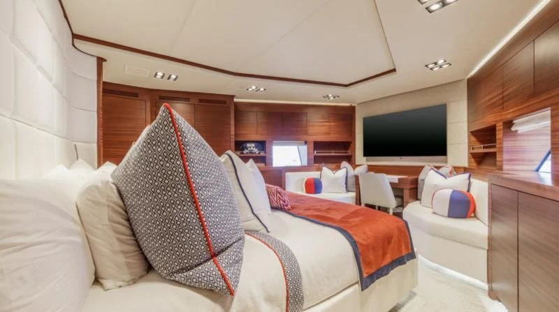 a room with a bed and a television aboard PRIMA MEA Yacht for Sale