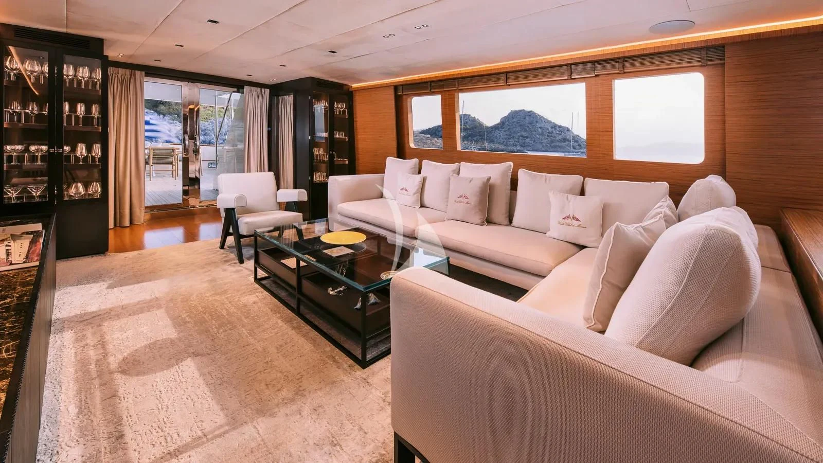 a room with a couch and a coffee table aboard XIPHIAS Yacht for Charter