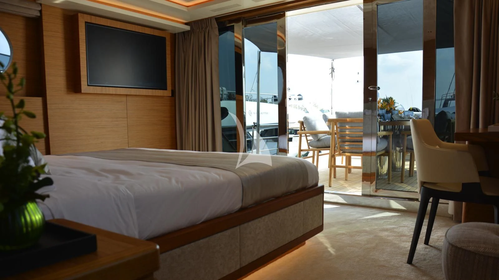 a hotel room with a bed and a tv aboard XIPHIAS Yacht for Charter