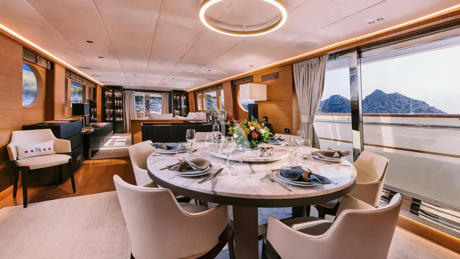 a dining room with a large window aboard XIPHIAS Yacht for Charter